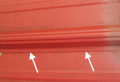 Which are the male and female flanges of a metal roof panel?